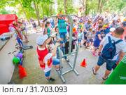 Russia Samara June 2019: a girl passes the standards for pulling up on a horizontal bar in the park sunny day. Text in Russian: Judge Gto. Редакционное фото, фотограф Акиньшин Владимир / Фотобанк Лори