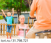 Children are teetering on the swing. Стоковое фото, фотограф Яков Филимонов / Фотобанк Лори