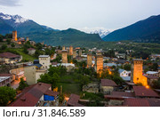 Panoramic view of Svan Towers in Mestia at sunset, Svaneti region, Georgia. It is a highland townlet in the northwest of Georgia, at an elevation of 1500 meters in the Caucasus Mountains. Редакционное фото, фотограф Mikhail Starodubov / Фотобанк Лори
