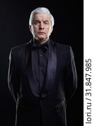 Mature icy calm man in black suit looking at the camera with a hypnotic look. Стоковое фото, фотограф Сергей Пристяжнюк (Serg Zastavkin) / Фотобанк Лори