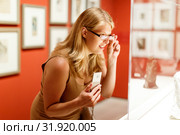 Woman looking at showcases with exhibits. Стоковое фото, фотограф Яков Филимонов / Фотобанк Лори