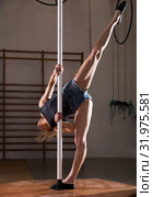 Young woman in denim shorts practicing pole dancing. Стоковое фото, фотограф Яков Филимонов / Фотобанк Лори
