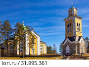 Beautiful view of ancient Lutheran Church whith bell tower in kerimaki of southern Savo province on a sunny spring day. The biggest wooden cathedral in Scandinavia and in the world. Eastern Finland (2019 год). Редакционное фото, фотограф Алексей Ширманов / Фотобанк Лори