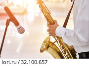 Young jazz musician plays the saxophone in a large hall. Стоковое фото, фотограф Олег Белов / Фотобанк Лори