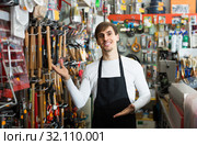 male seller posing at tooling section of household store. Стоковое фото, фотограф Яков Филимонов / Фотобанк Лори