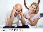 Mature girlfriend consoling grieving man sitting apart. Стоковое фото, фотограф Яков Филимонов / Фотобанк Лори