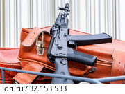 Kalashnikov ak-47 and vintage travel suitcases. Стоковое фото, фотограф FotograFF / Фотобанк Лори