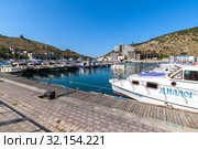 Sevastopol, Crimea - July 3. 2019. Boat in the Balaklava Bay. Редакционное фото, фотограф Володина Ольга / Фотобанк Лори