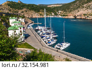 Sevastopol, Crimea - July 3. 2019. Many boats in Balaklava Bay. Редакционное фото, фотограф Володина Ольга / Фотобанк Лори