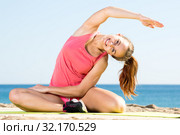 Woman exercising yoga at sea beach. Стоковое фото, фотограф Яков Филимонов / Фотобанк Лори