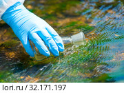 close up of a scientist's river drawing water into a research flask from a stream. Стоковое фото, фотограф Константин Лабунский / Фотобанк Лори