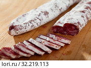 Spanish sausage fuet on a wooden table, closeup. Стоковое фото, фотограф Яков Филимонов / Фотобанк Лори