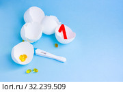 Long-awaited pregnancy after unsuccessful IVF. Positive pregnancy test, pills, eggshell. Стоковое фото, фотограф Papoyan Irina / Фотобанк Лори
