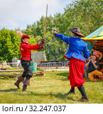 Russia, Samara, June 2016: A battle of musketeers on swords for the audience of the festival "Journey to the Past", which takes place near Samara on a sunny summer day. Редакционное фото, фотограф Акиньшин Владимир / Фотобанк Лори