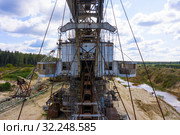 Old rusty multi bucket excavator, giant stacker, absetzer in sandy career. Стоковое фото, фотограф Mikhail Starodubov / Фотобанк Лори