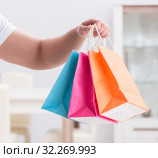 Young man with gift bag at home preparing suprise for wife. Стоковое фото, фотограф Elnur / Фотобанк Лори