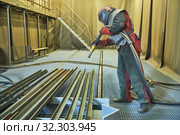 Sandblasting in chamber. Worker makes sand blast cleaning of metal detail. Стоковое фото, фотограф Дмитрий Калиновский / Фотобанк Лори