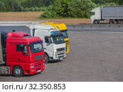 Trucks in the Parking lot near the highway. Стоковое фото, фотограф Юрий Бизгаймер / Фотобанк Лори