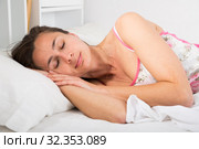 Cute adult woman in pygamas sleeping in bed in bedroom. Стоковое фото, фотограф Яков Филимонов / Фотобанк Лори