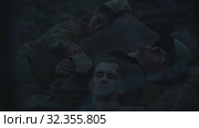19-10-2019 RUSSIA, REPUBLIC OF TATARSTAN: a lot of wounded soldiers covered in blood lying on each other at night - backstage of filming military movie. Редакционное видео, видеограф Константин Шишкин / Фотобанк Лори