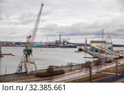 View of one of port areas of Kotka, port cranes, Sunila pulp and paper mill and Vellamo maritime centre (2019 год). Редакционное фото, фотограф Юлия Бабкина / Фотобанк Лори