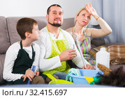 Tired parents with son dressed for cleaning. Стоковое фото, фотограф Яков Филимонов / Фотобанк Лори