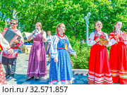 Russia, Samara, June 2017: smart girls in national clothes sing for city residents on the embankment of the Volga River on a sunny summer day. Редакционное фото, фотограф Акиньшин Владимир / Фотобанк Лори