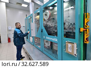Moscow, Russia - Dec. 5.2019. Worker at the machine in Mikron - largest plant for production of chips. Zelenograd. Редакционное фото, фотограф Володина Ольга / Фотобанк Лори