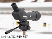 Close-up view of professional sports monocle Leupold looking at shooting range of biathlon stadium. Regional Junior biathlon competitions East of Cup (2019 год). Редакционное фото, фотограф А. А. Пирагис / Фотобанк Лори