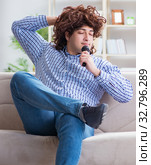 The funny man singing songs in karaoke at home. Стоковое фото, фотограф Elnur / Фотобанк Лори