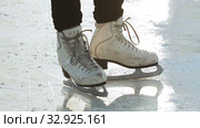 A woman standing on ice rink in figure skates. Стоковое видео, видеограф Константин Шишкин / Фотобанк Лори