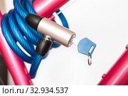 Closed cable lock with permanently integrated locking mechanism, looped cable, white background. Стоковое фото, фотограф Кекяляйнен Андрей / Фотобанк Лори