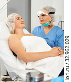 Doctor is examining woman patient before the procedure. Стоковое фото, фотограф Яков Филимонов / Фотобанк Лори