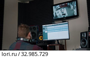 A man sound engineer recording the sound for a young man rapper. Стоковое видео, видеограф Константин Шишкин / Фотобанк Лори
