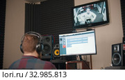 A man sound engineer watching the rapper while recording his audio tracks. Стоковое видео, видеограф Константин Шишкин / Фотобанк Лори