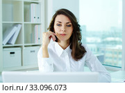 Pensive business woman looking at the screen of her laptop. Стоковое фото, фотограф Dmitriy Shironosov / PantherMedia / Фотобанк Лори