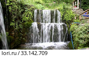 A small picturesque waterfall in the village of Argirupoli on the island of Crete, Greece (2017 год). Стоковое видео, видеограф Наталья Волкова / Фотобанк Лори