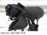 Close-up view of professional sports monocle looking at shooting range of biathlon arena. Junior biathlon competitions East of Cup (2019 год). Редакционное фото, фотограф А. А. Пирагис / Фотобанк Лори