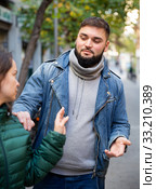 Woman stopping man bothering her on street. Стоковое фото, фотограф Яков Филимонов / Фотобанк Лори