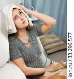 Woman with wet towel on her forehead. Стоковое фото, фотограф Яков Филимонов / Фотобанк Лори