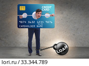 Businessman in credit card burden concept in pillory. Стоковое фото, фотограф Elnur / Фотобанк Лори