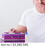 Young man with gift bag at home preparing suprise for wife. Стоковое фото, фотограф Elnur / Фотобанк Лори