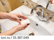 Person taking soap from soap-dish for hands washing, personal hygiene in home. Стоковое фото, фотограф Кекяляйнен Андрей / Фотобанк Лори