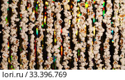 In foreground 3D glasses, which then disappear from frame. Defocused dynamic background of garlands from popcorn and golden sparkling tinsel. Garlands of popcorn for sports and movie news. Стоковое видео, видеограф Dmitry Domashenko / Фотобанк Лори