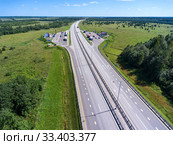 Wide highway M-11 passing with parking and rest area. View from above. The Moscow-Saint Petersburg motorway designed as the M11 Neva is in Russia. Стоковое фото, фотограф Кекяляйнен Андрей / Фотобанк Лори