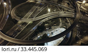 Aerial view of lighted highway road junctions at night. Стоковое видео, видеограф Яков Филимонов / Фотобанк Лори