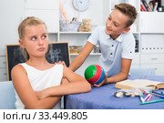 Boy is excusing for the offendedly girl and offering to play ball. Стоковое фото, фотограф Яков Филимонов / Фотобанк Лори