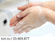 Children's soapy hands under running water under bathroom sink faucet. Стоковое фото, фотограф Попова Ольга / Фотобанк Лори