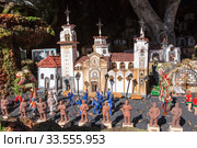 Papier mache installation of city historical model. Visitors watch the smaller scale scene. The Basilica of the Royal Marian Shrine of Our Lady (2016 год). Редакционное фото, фотограф Кекяляйнен Андрей / Фотобанк Лори