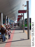 Passengers wait for departure of intercity bus at Titsa bus terminal. Titsa is a operator of public bus service in Tenerife (2016 год). Редакционное фото, фотограф Кекяляйнен Андрей / Фотобанк Лори